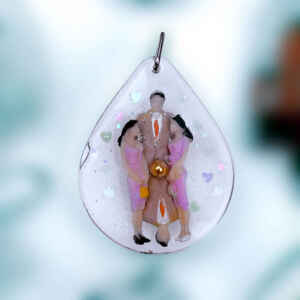 Tear drop pendant containing mirrored people and a gold ball.