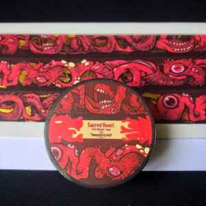 A photo of a packaged roll of washi tape. It reads: Sacred Beast Gold Foil Washi Tape. The design on which is the long, repeating body of a flesh leviathan. Featuring multiple mouths, eyes, and exposed organs!