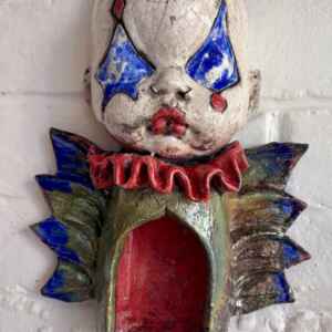 Winged Baby Jester candle holder